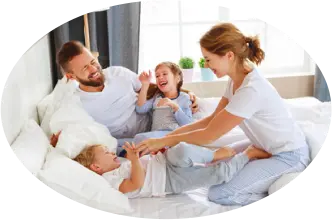 Family smiling on a bed - Don't let bed bugs take over your furniture with Seitz Brothers in Tamaqua PA